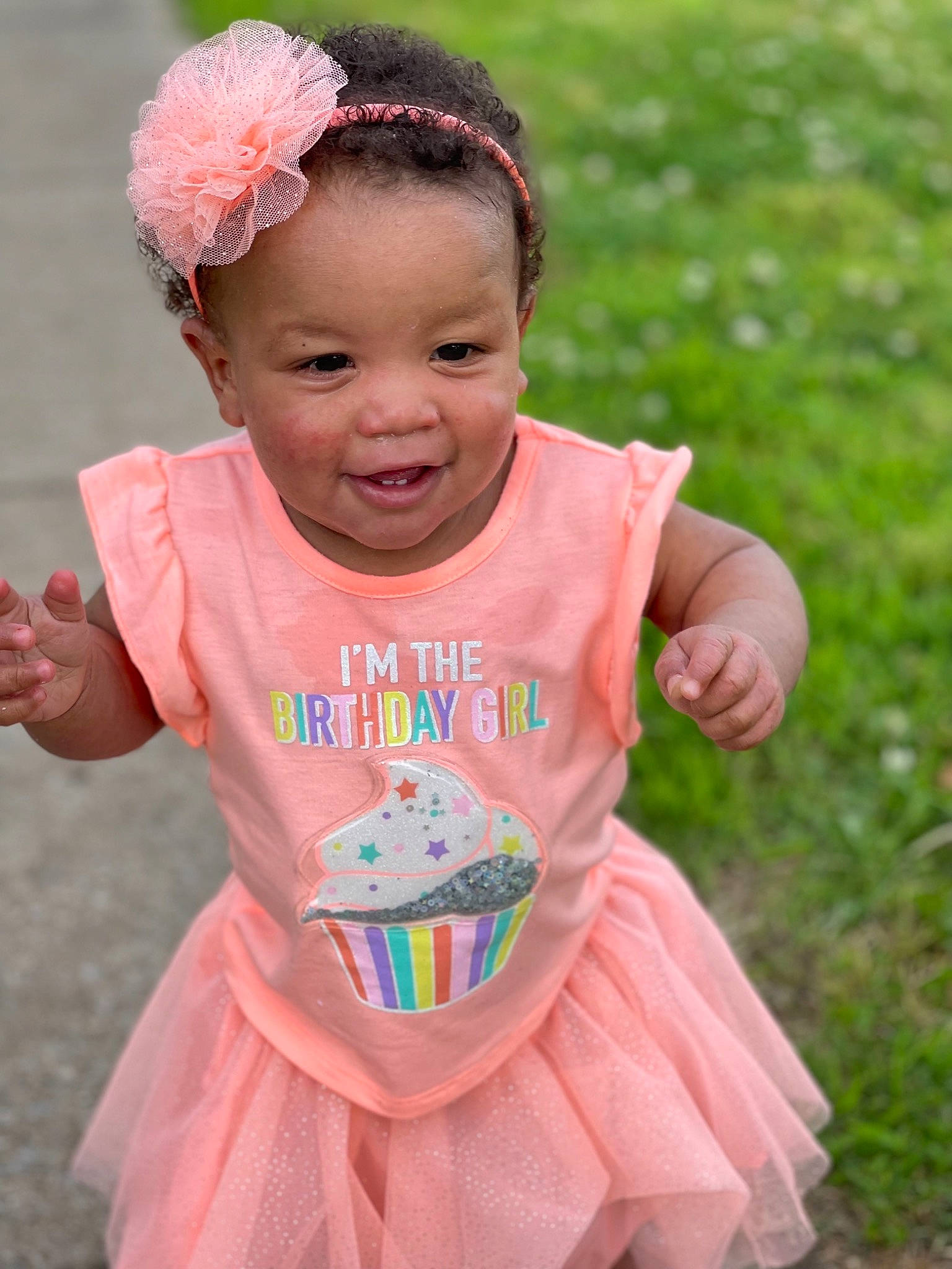 Lai Lani joined the competition — help win amazing prizes! baby, baby_toddler_clothing, child, dress, face, finger, fun, gesture, grass, hairstyle, happy, leisure, magenta, people_in_nature, person, pink, sleeve, smile, summer, t_shirt