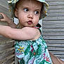 toddler, child, baby, hat, floral, dress, outdoor, wooden_wall, curious, pouting, person, skin, arm, summer, sunhat, colorful, nature_pattern, portrait, support, casual