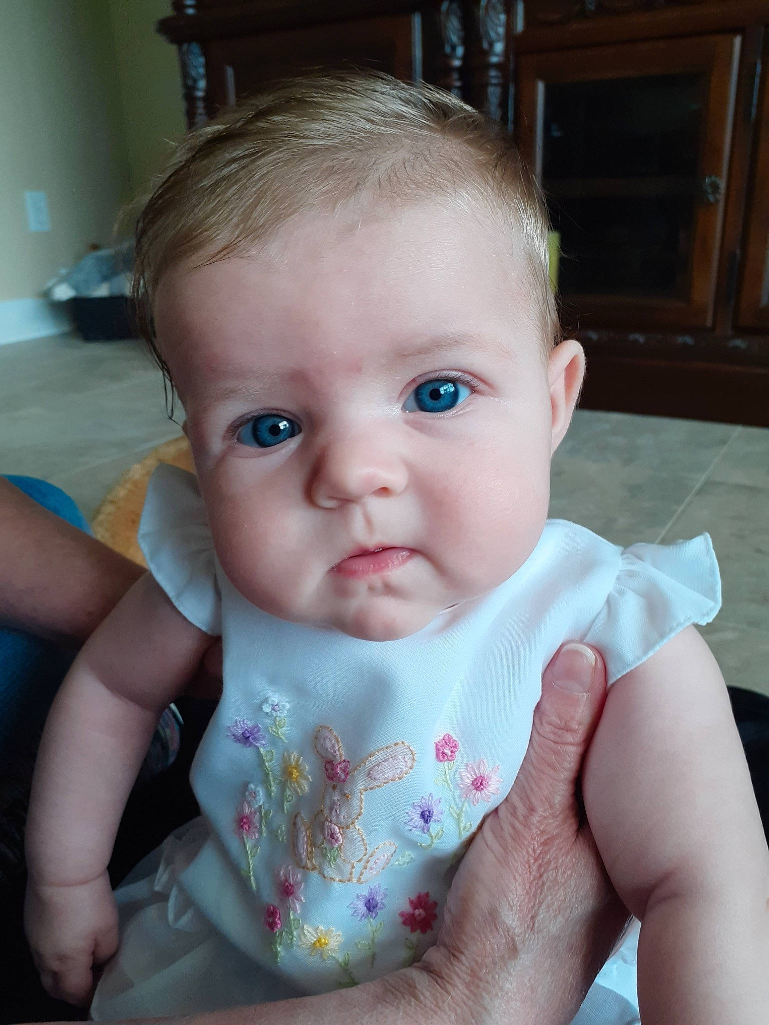 Maisie is registered to the contest to win money with this photo: baby, blond, cheek, child, chin, ear, eye, face, finger, forehead, hand, head, iris, lip, mouth, nose, person, sitting, skin, toddler