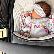 Kinsley is registered to the contest to win money with this photo: baby, infant, stroller, blanket, knitted_sweater, headband, sleeping, cushion, pastel_colors, floral_pattern, white_clothing, baby_clothes, baby_bedding, baby_accessories, newborn, cozy, child, resting, soft_texture, indoor