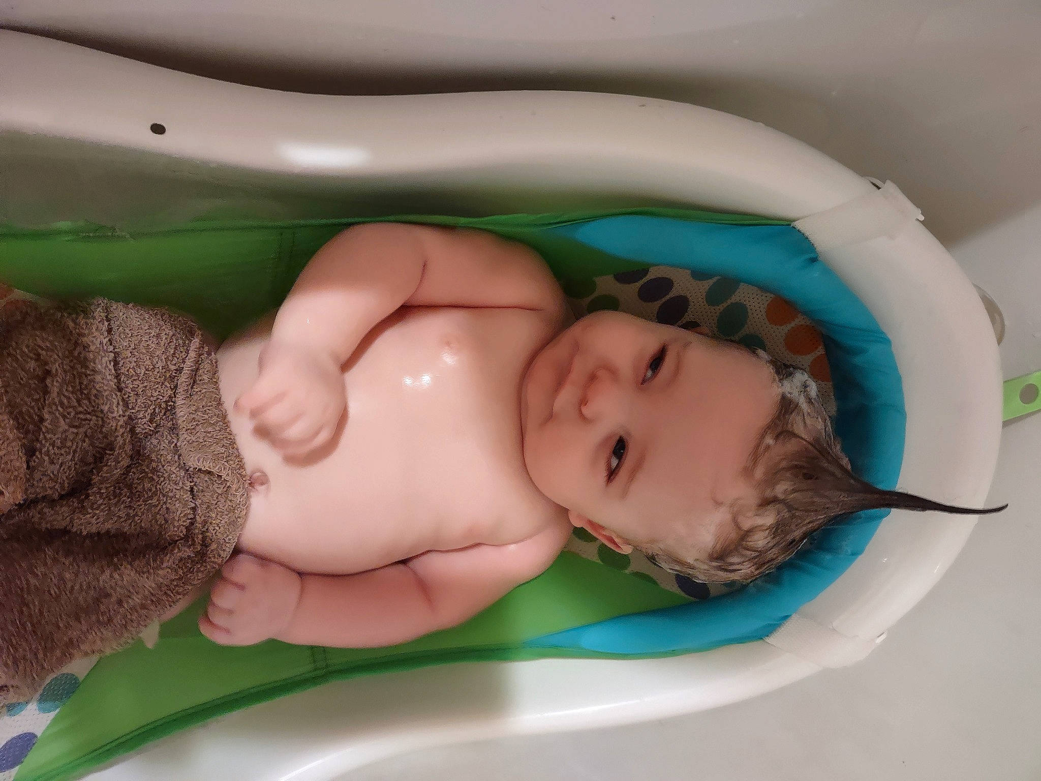 Dylan is registered to the contest to win money with this photo: arm, baby, baby_products, baby_safety, baby_toddler_clothing, bathing, bathtub, bedtime, cheek, chest, child, comfort, fun, grass, linens, person, room, skin, thumb, toddler