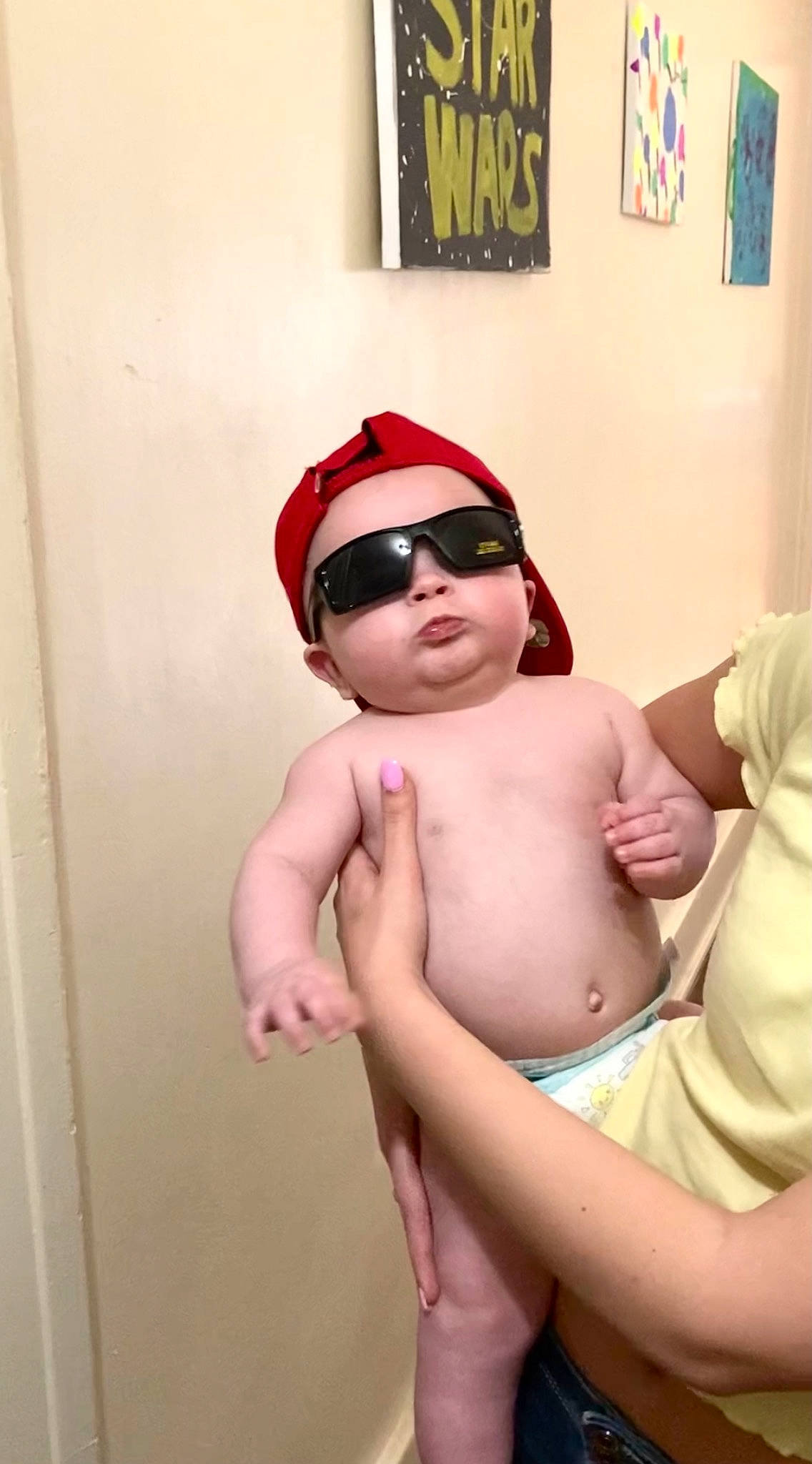 Wesley is registered to the contest to win money with this photo: baby, cap, chest, comfort, elbow, eyewear, glasses, goggles, hat, headwear, human_body, leg, mouth, person, picture_frame, stomach, sunglasses, thigh, thumb, toddler