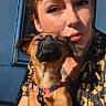 animal, closeup, clothing, collar, dog, expression, face, freckles, happy, leash, nose_ring, outdoor, pattern, pet, portrait, selfie, short_hair, sunlight, tattoo, woman