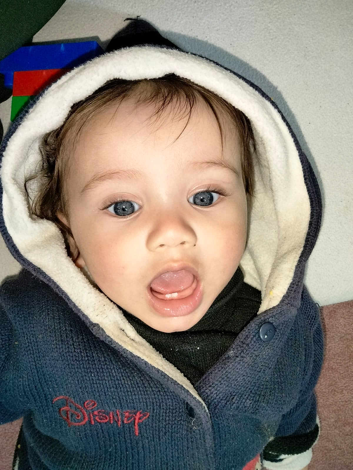 Abdur joined the competition — help win amazing prizes! toddler, child, face, hoodie, disney, blue_clothing, open_mouth, curious_expression, indoor, fleece, button, toy_blocks, closeup, portrait, young_child, baby_teeth, warm_clothing, headwear, cute, person
