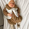 Alya a rejoint le concours — aidez-le/la à gagner de superbes lots ! baby, sleeping, headband, bow, brown_clothing, white_vest, blanket, soft_texture, infant, cute, peaceful, toddler, cozy, lying_down, child, footwear, socks, bear_design, indoors, portrait