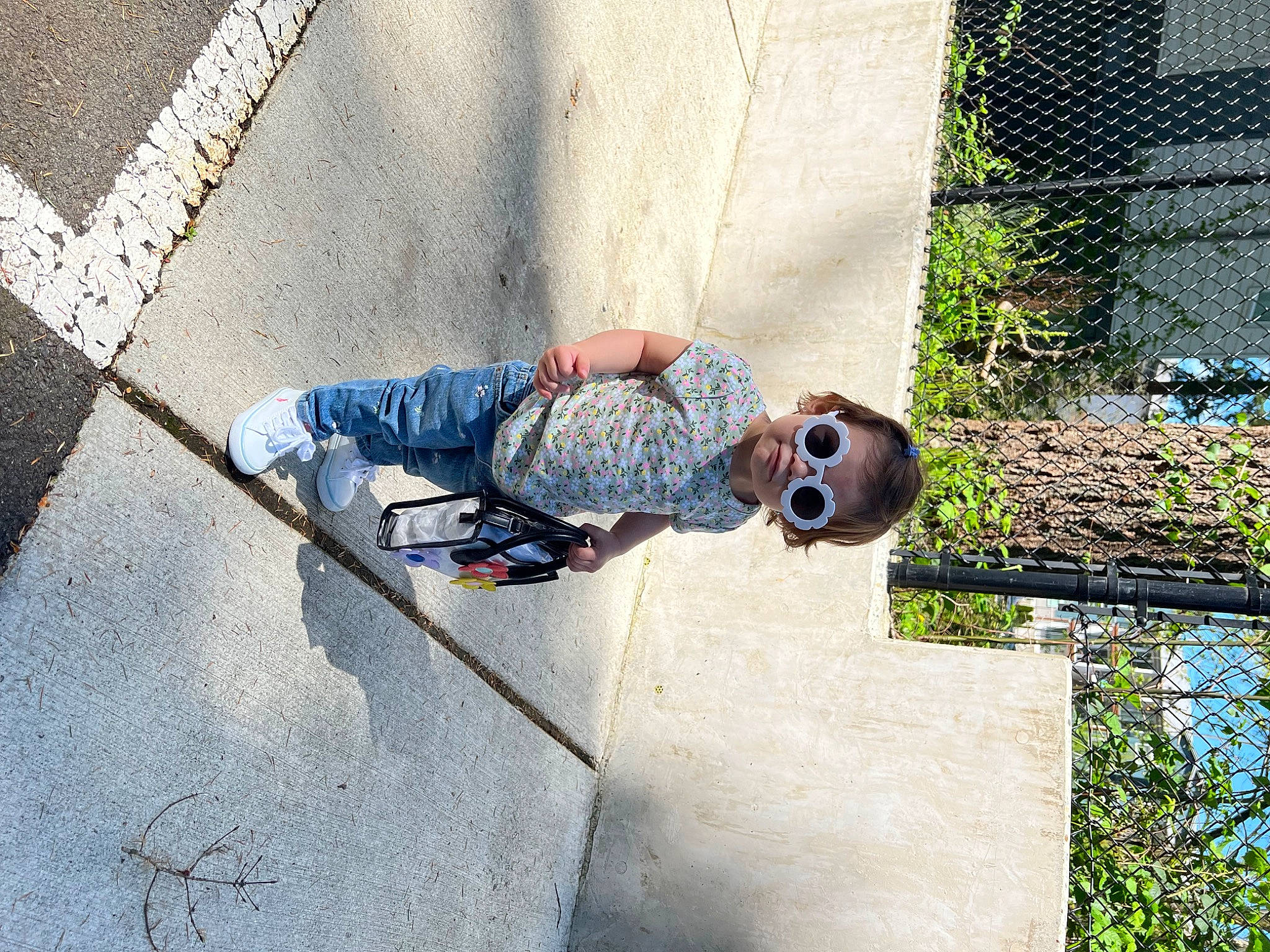 Sol joined the competition — help win amazing prizes! asphalt, cement, child, concrete, denim, eyewear, grass, leisure, pattern, person, plant, recreation, road_surface, shadow, sidewalk, sitting, sunglasses, toddler, tree, water