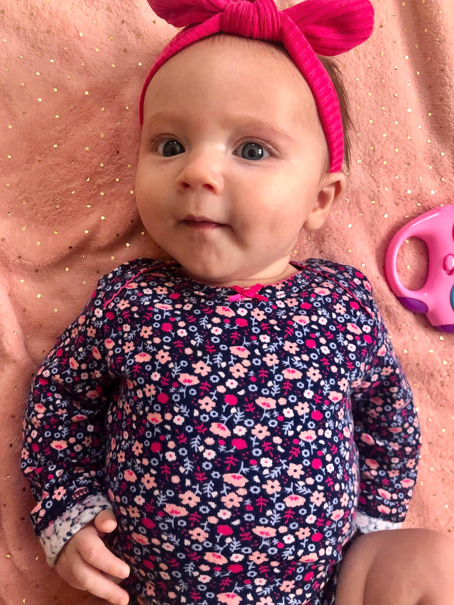 Maisy is registered to the contest to win money with this photo: baby, baby_products, baby_toddler_clothing, cheek, child, child_model, clothing, design, ear, face, hair_accessory, headgear, lip, pattern, person, pink, product, skin, sleeve, toddler