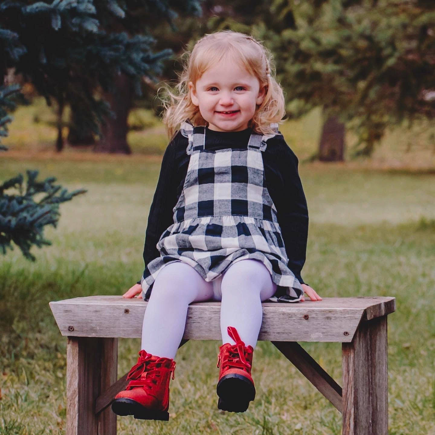 Maisy joined the competition — help win amazing prizes! dress, eye, face, grass, hair, hairstyle, happy, head, joy, leg, outerwear, people_in_nature, person, plaid, plant, shoe, sleeve, smile, street_fashion, tartan