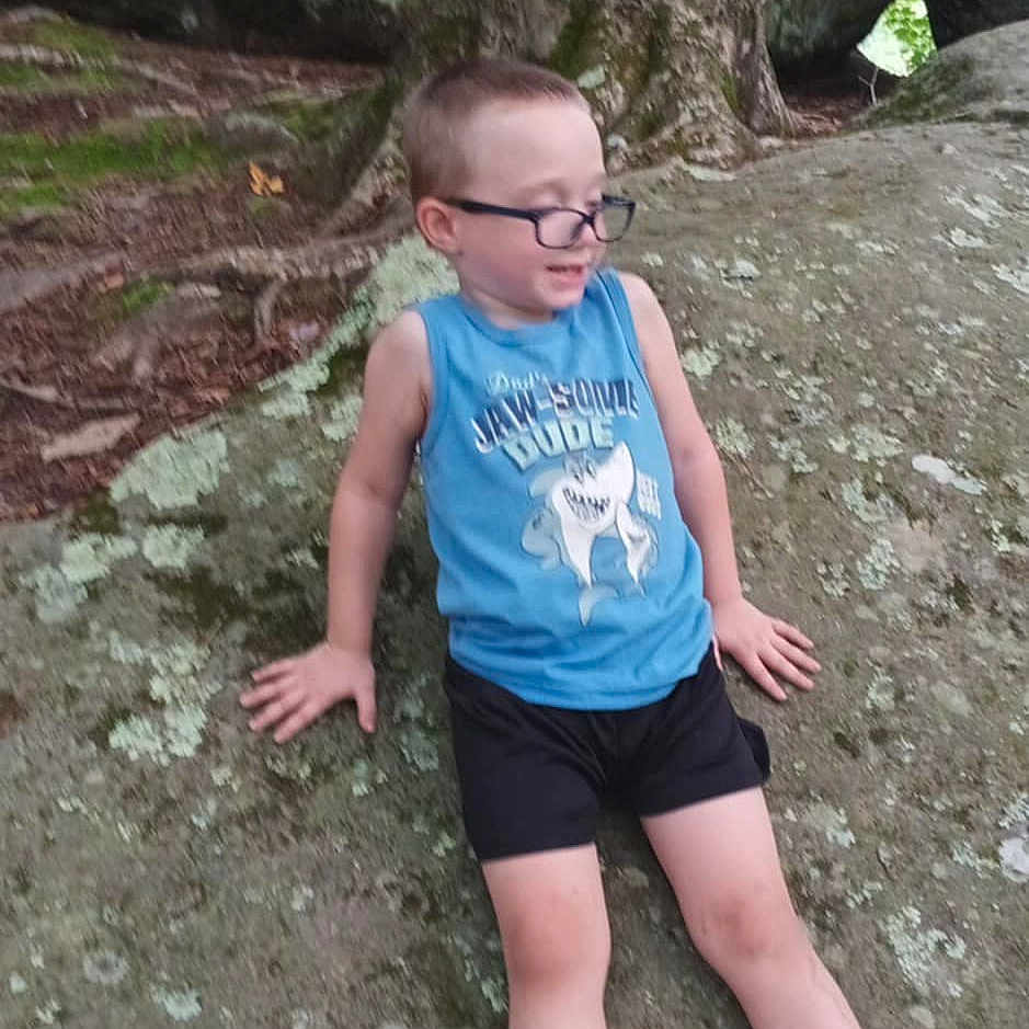 Collin joined the competition — help win amazing prizes! boy, clothing, face, grass, head, land, nature, outdoors, park, person, photography, plant, portrait, rock, shorts, t_shirt, tree, vegetation, wilderness, woodland