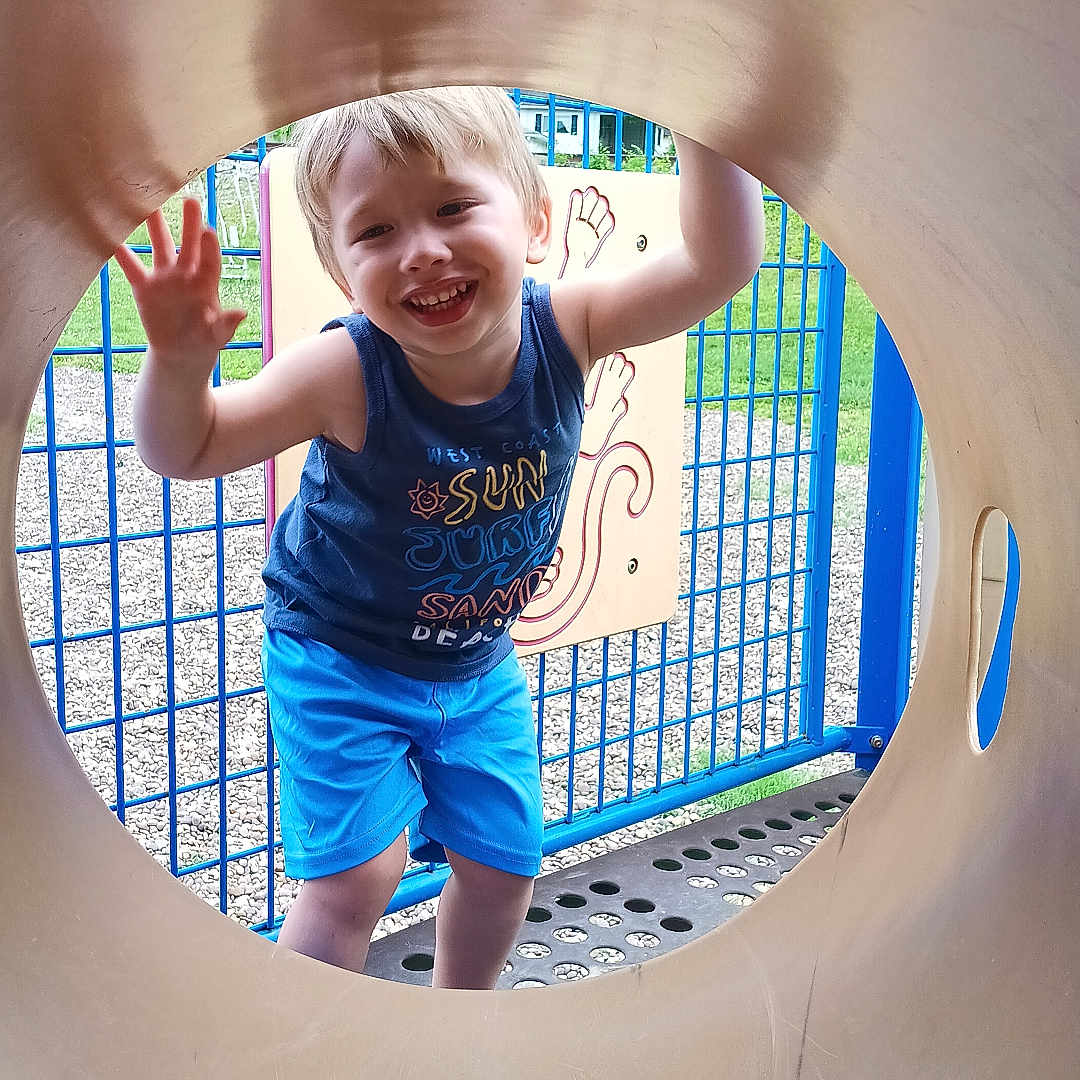 Johnathan is registered to the contest to win money with this photo: bodypart, boy, child, clothing, face, finger, head, indoors, male, outdoorplayarea, outdoors, pants, person, photography, playarea, portrait, shorts, slide, t_shirt, toy