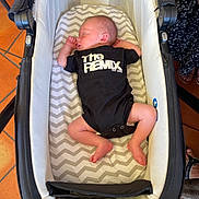 Daniel a rejoint le concours — aidez-le/la à gagner de superbes lots ! baby, newborn, sleeping, bassinet, onesie, clothing, chevron_pattern, mattress, indoor, floor_tiles, terracotta, furniture, wicker, feet, hands, head, person, infant, cozy, resting