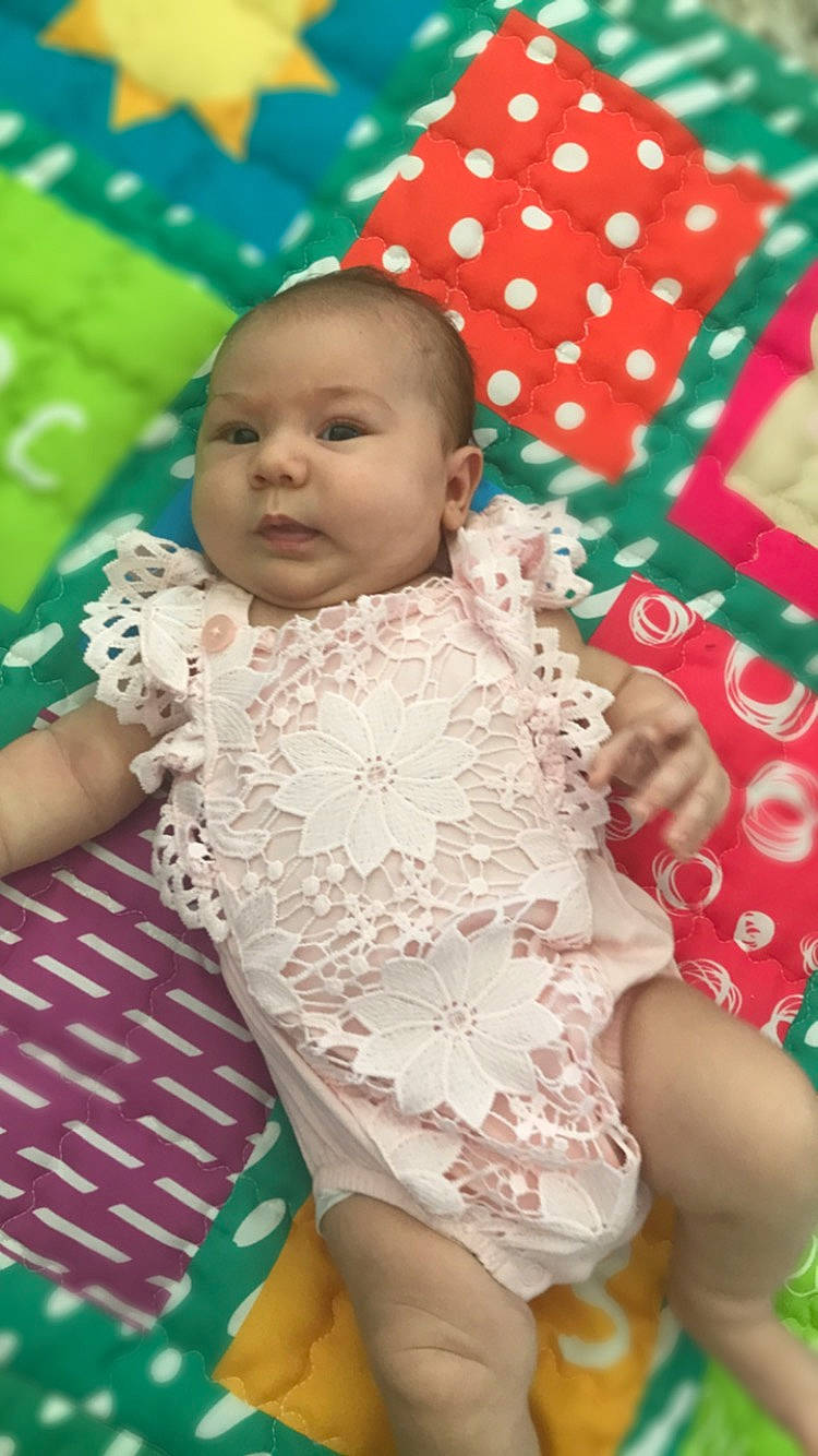 Davina is registered to the contest to win money with this photo: baby, baby_products, baby_toddler_clothing, cheek, child, event, finger, fun, happy, human_body, linens, nose, pattern, person, pink, play, skin, sleeve, textile, thigh