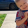 child, boy, smile, outdoor, sidewalk, car, grass, shirt, spiderman, happy, playful, daylight, portrait, casual, short_hair, person, clothing, concrete, vehicle, sunny