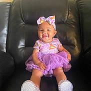 Sheliah is registered to the contest to win money with this photo: baby, child, smiling, purple_dress, bow, headband, sitting, leather_couch, indoor, happy, cute, sparkly_shoes, tutu, fashion, portrait, infant, adorable, one_person, young_child, casual