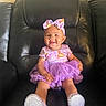 baby, child, smiling, purple_dress, bow, headband, sitting, leather_couch, indoor, happy, cute, sparkly_shoes, tutu, fashion, portrait, infant, adorable, one_person, young_child, casual