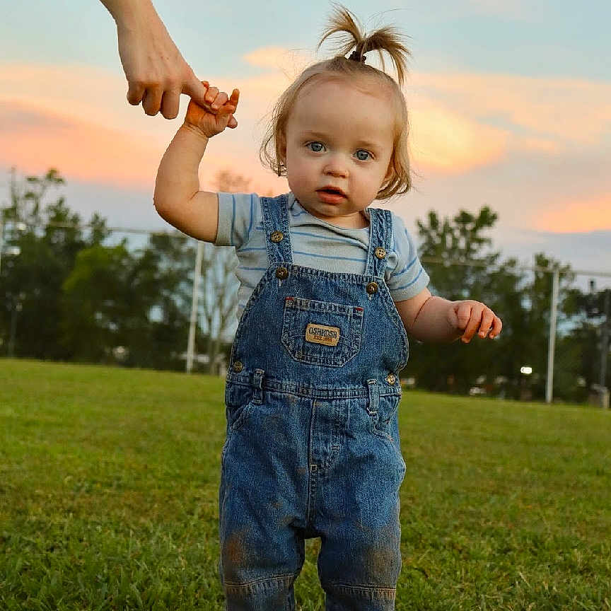 Oden joined the competition — help win amazing prizes! blue_eyes, casual_clothing, child, cute, denim, field, grass, green, hairstyle, hand, holding, nature, outdoor, overalls, person, sky, sunset, toddler, walking, young_child