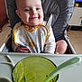 Méziane a rejoint le concours — aidez-le/la à gagner de superbes lots ! baby, high_chair, bib, smile, face, child, indoor, feeding, glass, spoon, happy, cute, person, seatbelt, table, furniture, meal, food, young, portrait