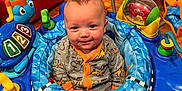 Cole is registered to the contest to win money with this photo: baby, balloon, couch, cream, dessert, face, food, furniture, happy, head, indoors, inflatable, outdoors, person, photography, playarea, portrait, sitting, smile, toy
