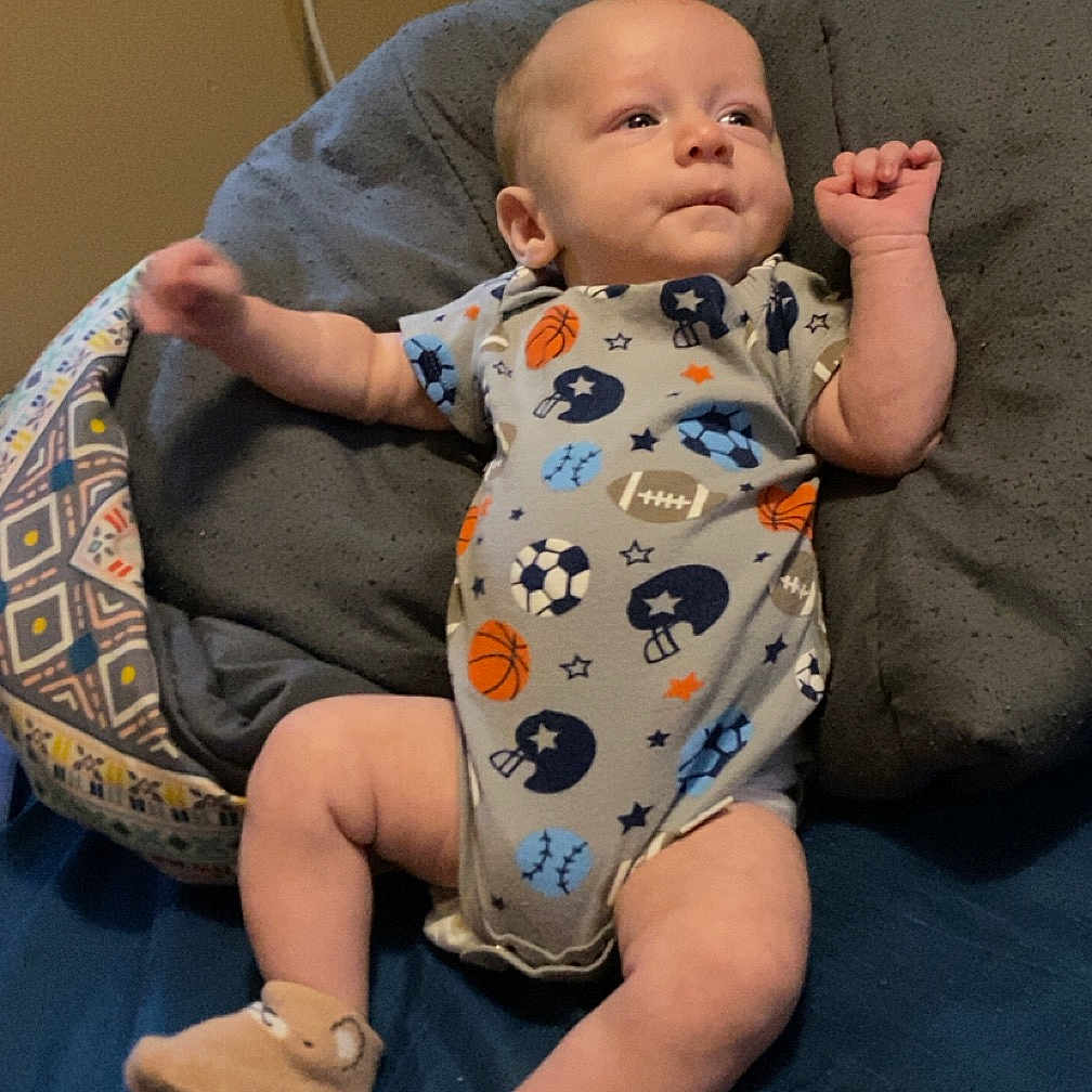 Landyn is registered to the contest to win money with this photo: baby, bodypart, clothing, couch, cushion, face, finger, footwear, furniture, hand, head, homedecor, newborn, pants, person, photography, portrait, sandal, shoe, sitting