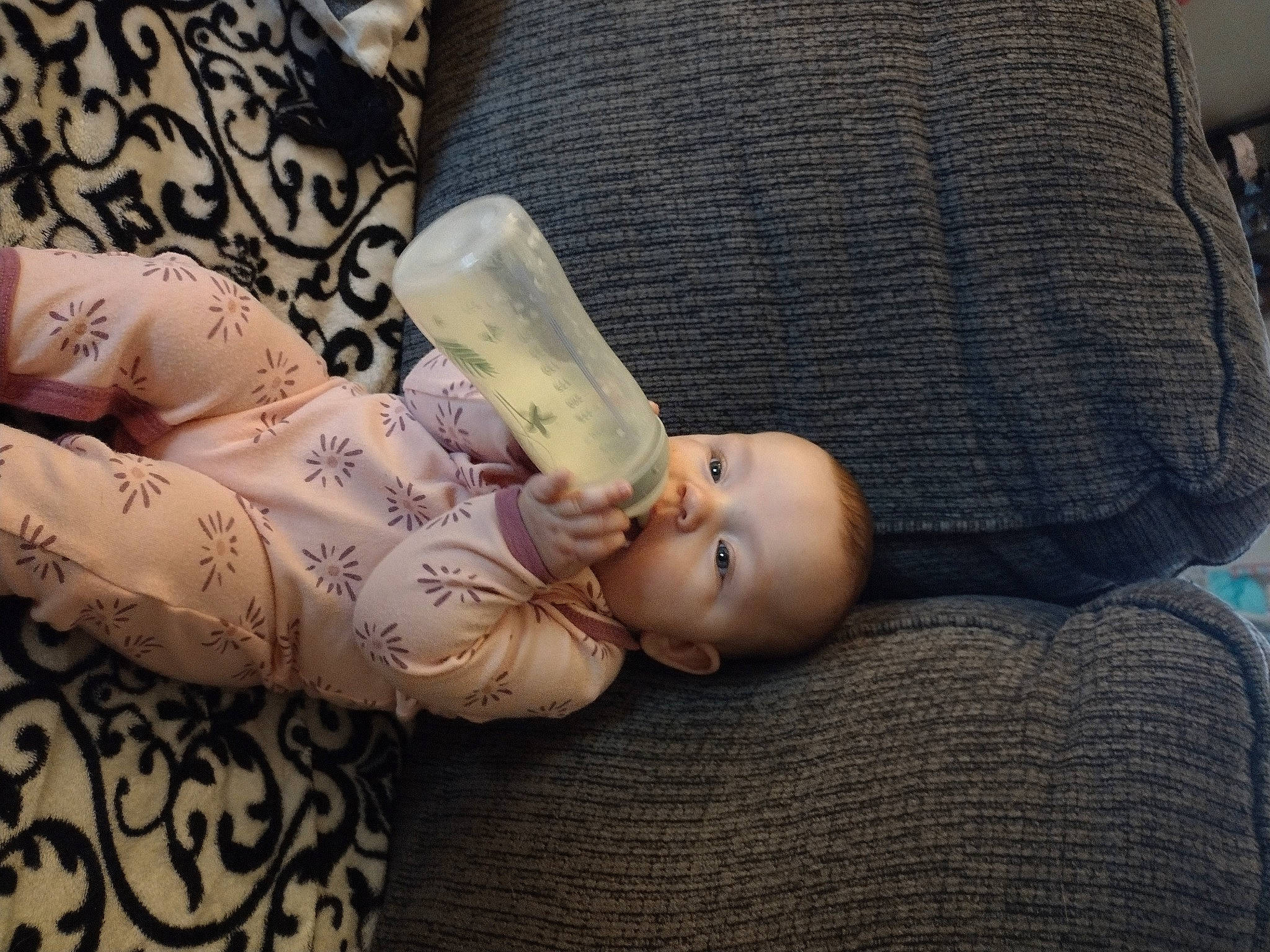 Cora is registered to the contest to win money with this photo: arm, baby, baby_toddler_clothing, cheek, child, comfort, elbow, eyelash, finger, hand, human_body, joint, lip, mouth, nail, neck, person, skin, sleeve, toddler