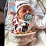 Adam Angelov participe au concours pour gagner de l'argent avec cette photo : baby, bed, blanket, closeup, clothing, comfort, cute, fendi, hat, indoors, infant, name_chain, newborn, pacifier, peaceful, person, resting, sleeping, soft_texture, wooden_beads