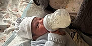 Adam Angelov participe au concours pour gagner de l'argent avec cette photo : baby, bed, blanket, bottle, child, comfort, cozy, cute, feeding, feeding_time, hat, indoors, infant, knitted_sweater, milk, newborn, person, resting, sleepwear, soft_toys_pattern