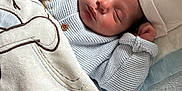 Adam Angelov participe au concours pour gagner de l'argent avec cette photo : newborn, baby, sleeping, blanket, hat, sweater, cozy, infant, cute, resting, plush, soft, tucked_in, indoors, child, peaceful, face, portrait, knitted, cushion