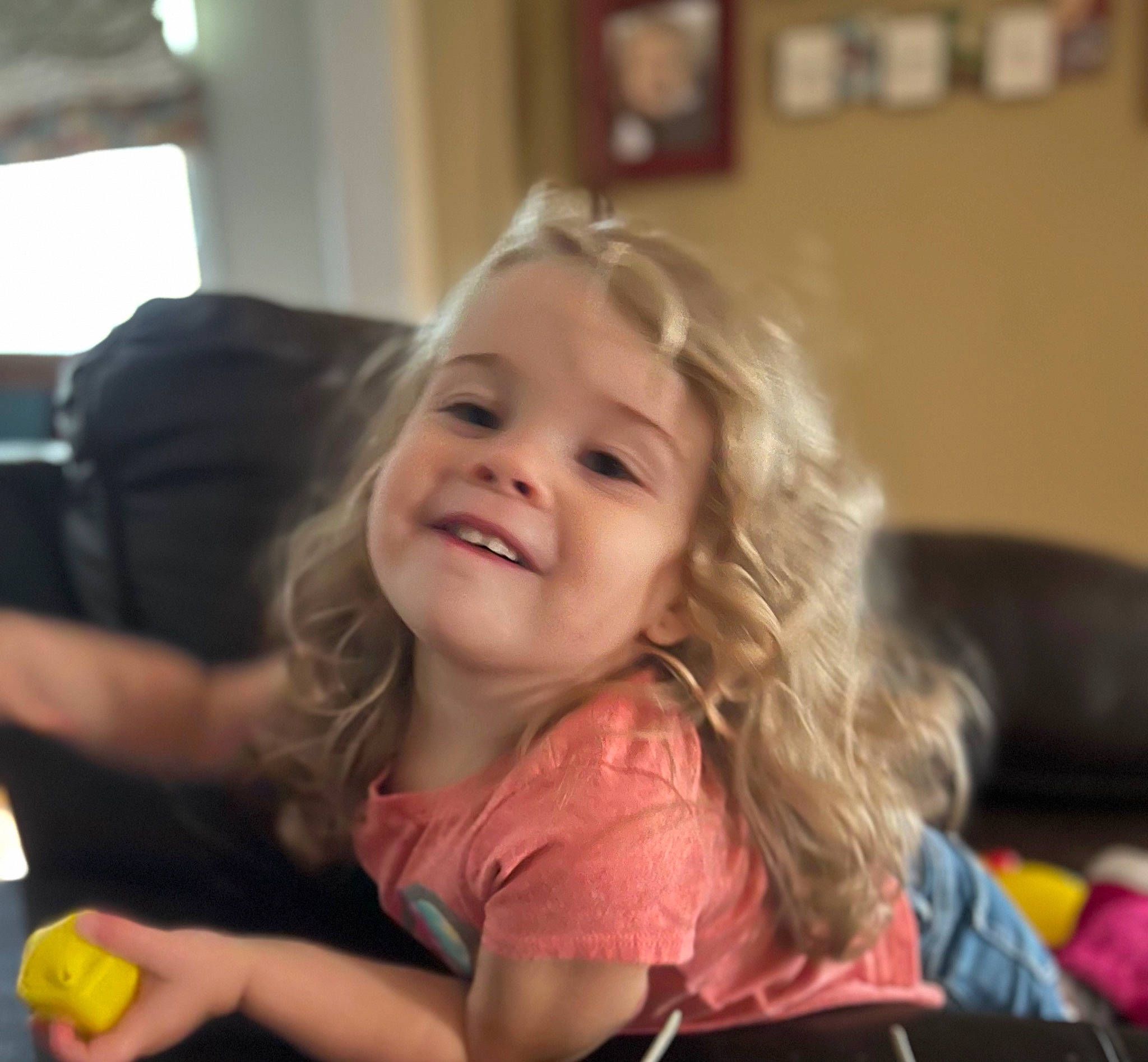 Izzy is registered to the contest to win money with this photo: blond, cheek, child, comfort, finger, fun, happy, iris, joy, laugh, leisure, person, picture_frame, play, room, sitting, skin, smile, t_shirt, thumb