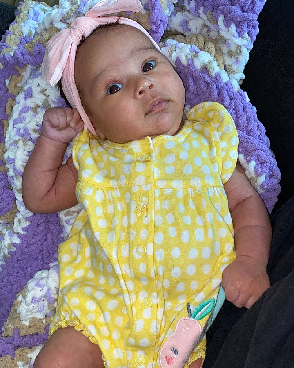 Alonna joined the competition — help win amazing prizes! baby, baby_toddler_clothing, cheek, child, dress, eye, face, facial_expression, head, headgear, headwear, iris, leaf, linens, person, pink, purple, skin, sleeve, textile