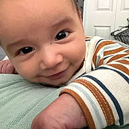 Zerek joined the competition — help win amazing prizes! baby, close_up, face, smile, eyes, hand, striped_clothing, indoor, soft_texture, infant, cute, child, portrait, resting, happy, young, skin, person, young_child, baby_girl