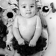 Leo is registered to the contest to win money with this photo: baby, infant, milky_bath, flower, sunflower, citrus_slices, leafy_greens, black_and_white, portrait, water, cute, child, small_hands, relaxing, soft_skin, nature_elements, artistic, calm, floating, peaceful
