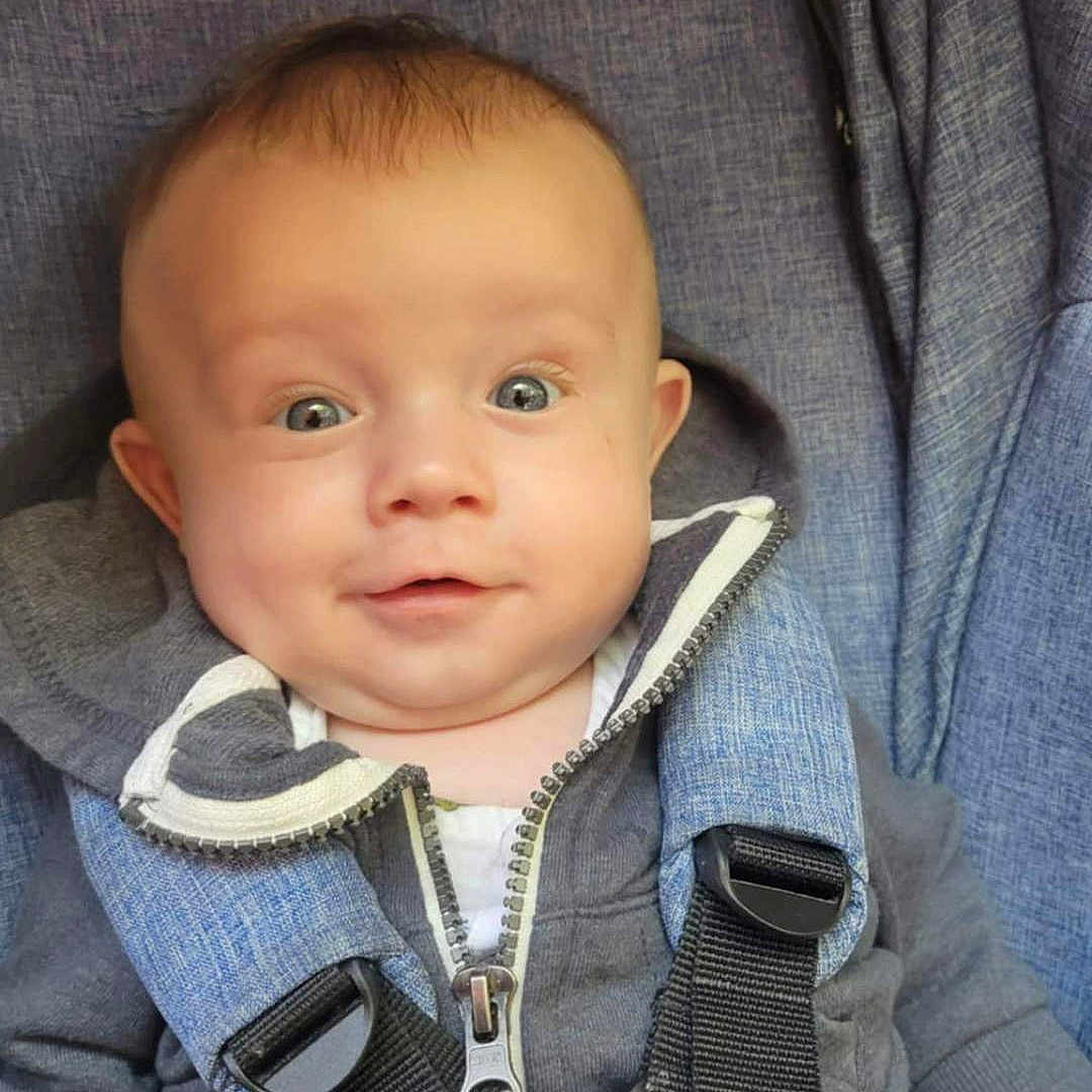 Nolan is registered to the contest to win money with this photo: accessories, baby, blazer, clothing, coat, cushion, electronics, face, hat, head, homedecor, jacket, jeans, knitwear, pants, person, photography, portrait, strap, sweater