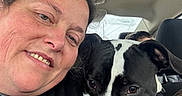 Echo is registered to the contest to win money with this photo: affection, animal, black_and_white_dog, car_interior, casual_clothing, closeup, companionship, dog, friendship, head, human, indoors, pet, portrait, seat, seatbelt, smile, transportation, travel, woman