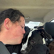 Echo is registered to the contest to win money with this photo: affection, animal, black_and_white, car_interior, closeup, clothing, companion, dog, emotional, face, headrest, human, love, person, pet, seat, seatbelt, snuggle, transportation, window