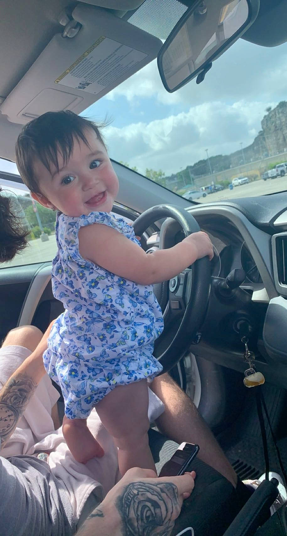 Charli is registered to the contest to win money with this photo: auto_part, automotive_design, automotive_exterior, automotive_mirror, beauty, car, car_seat, cloud, mode_of_transport, motor_vehicle, person, personal_luxury_car, rear_view_mirror, sky, smile, steering_part, steering_wheel, toddler, travel, vehicle