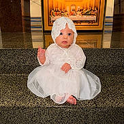 Evelyn is registered to the contest to win money with this photo: baby, barefoot, blue_eyes, bonnet, child, cute, decor, dress, expression, floor, indoor, infant, lace, last_supper, painting, portrait, religious_art, sitting, steps, white_dress