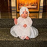 baby, barefoot, blue_eyes, bonnet, child, cute, decor, dress, expression, floor, indoor, infant, lace, last_supper, painting, portrait, religious_art, sitting, steps, white_dress