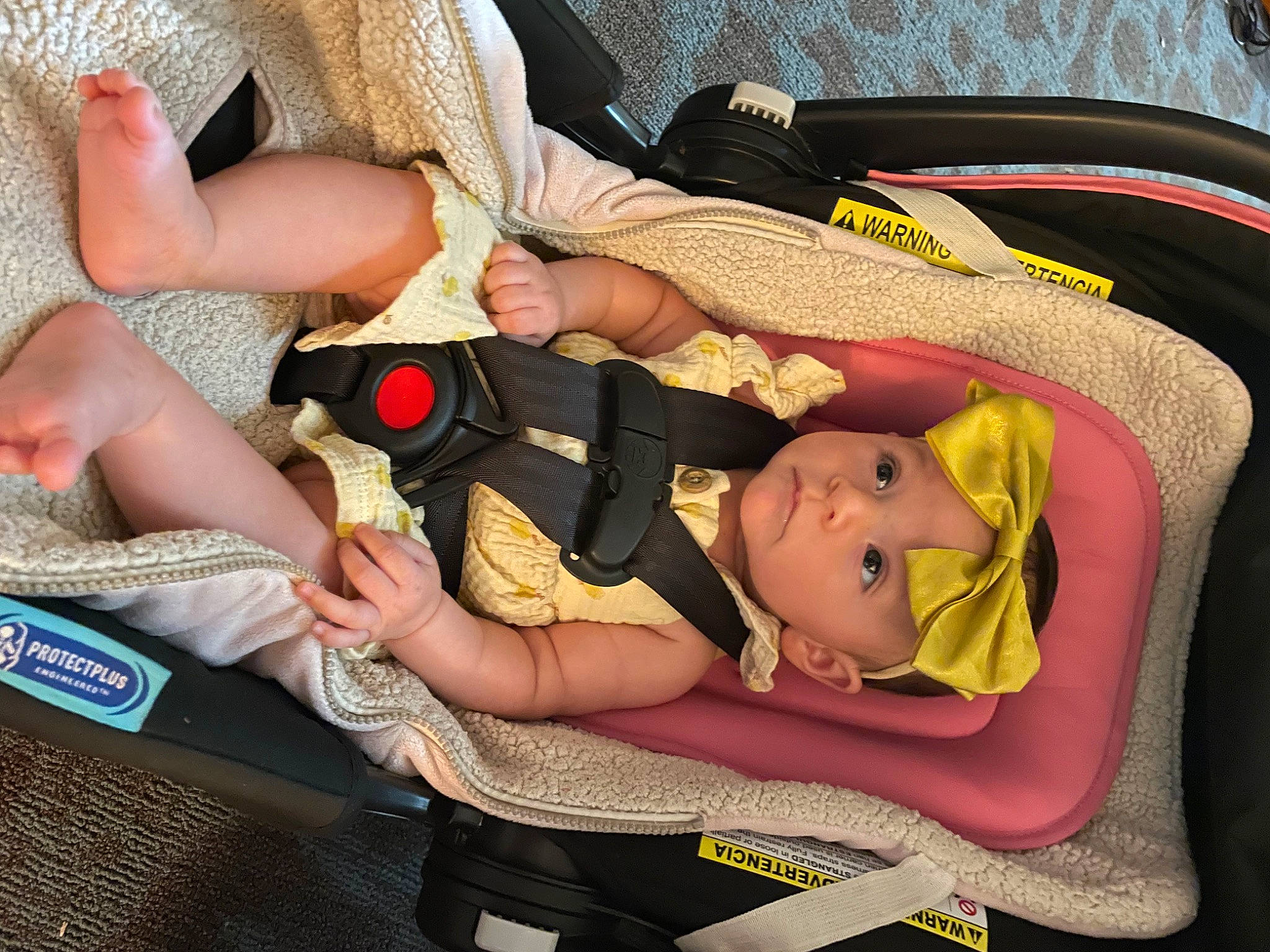 Ella-rose is registered to the contest to win money with this photo: baby, baby_carriage, baby_products, baby_toddler_clothing, car_seat, child, comfort, foot, fun, headwear, human_leg, knee, lap, pattern, person, sitting, thigh, thumb, toddler, yellow