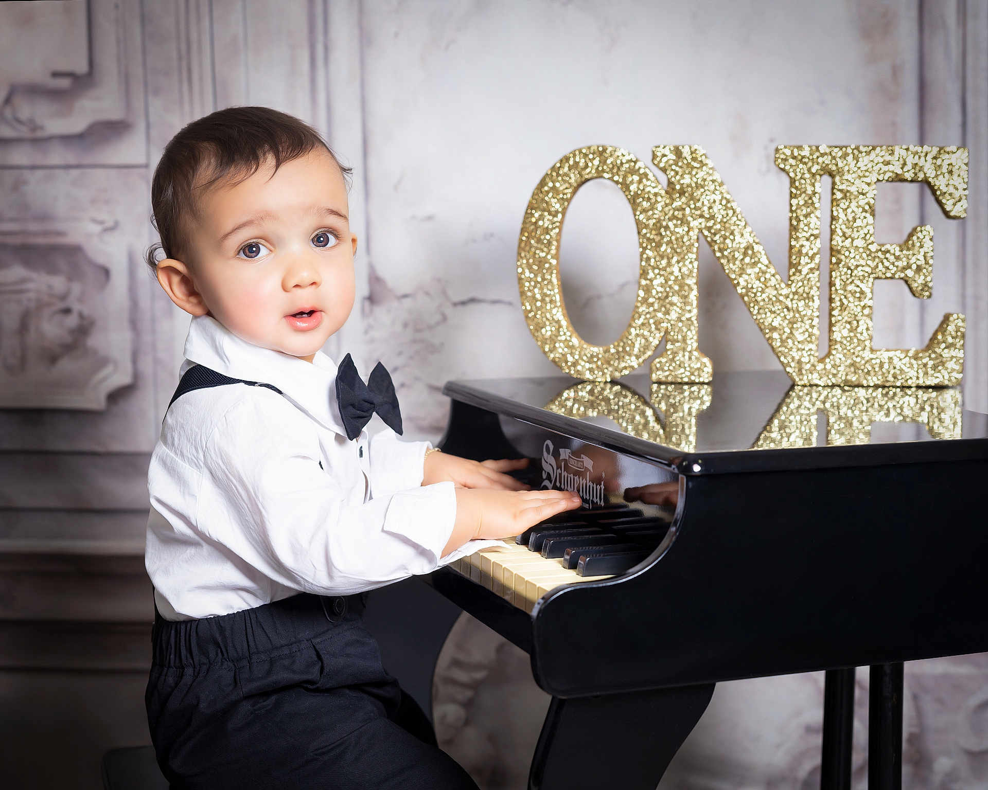 Luar joined the competition — help win amazing prizes! toddler, child, piano, miniature_piano, bow_tie, white_shirt, black_pants, celebration, birthday, number_one, gold_glitter, music, indoors, portrait, young_child, hands_on_piano, expression, face, cute, formal_wear