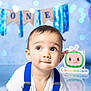 Luar joined the competition — help win amazing prizes! baby, child, blue_suspender, white_shirt, portrait, face, big_eyes, birthday, decorations, bokeh, background, cute, toddler, smiling, indoor, colorful, party, celebration, one_year, cartoon