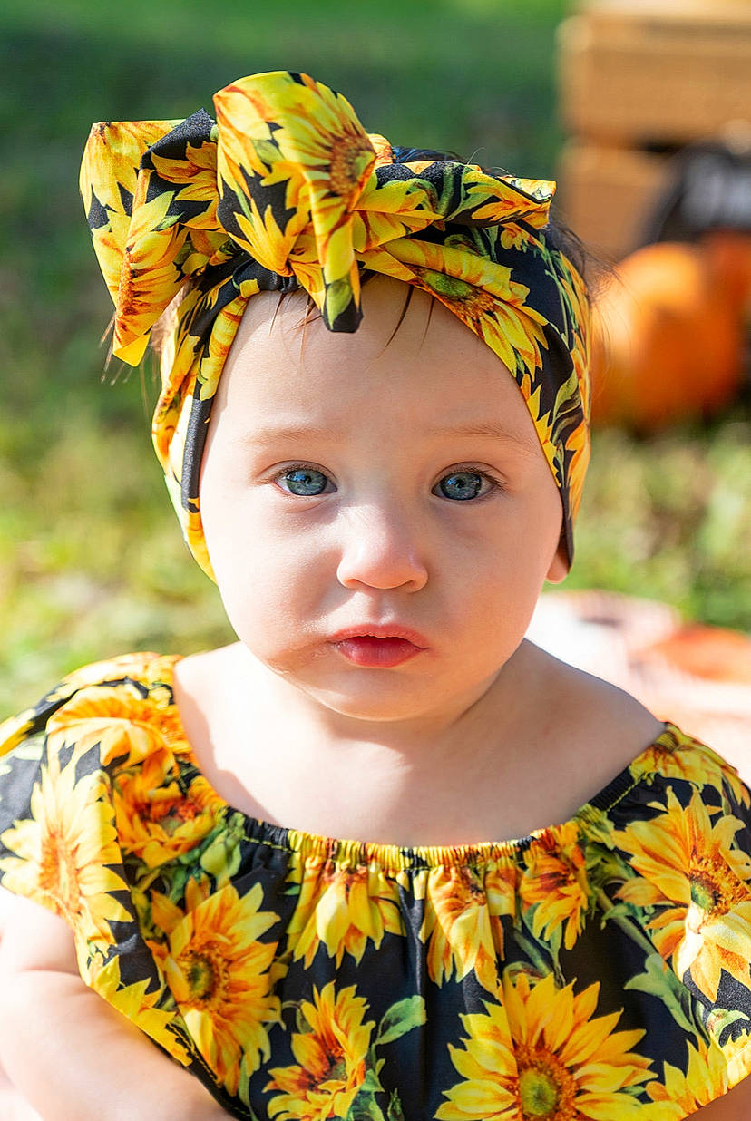 Gabriella joined the competition — help win amazing prizes! baby, baby_toddler_clothing, cap, costume_hat, dress, eye, grass, happy, head, headband, headgear, headpiece, headwear, helmet, neck, people_in_nature, person, photograph, plant, skin