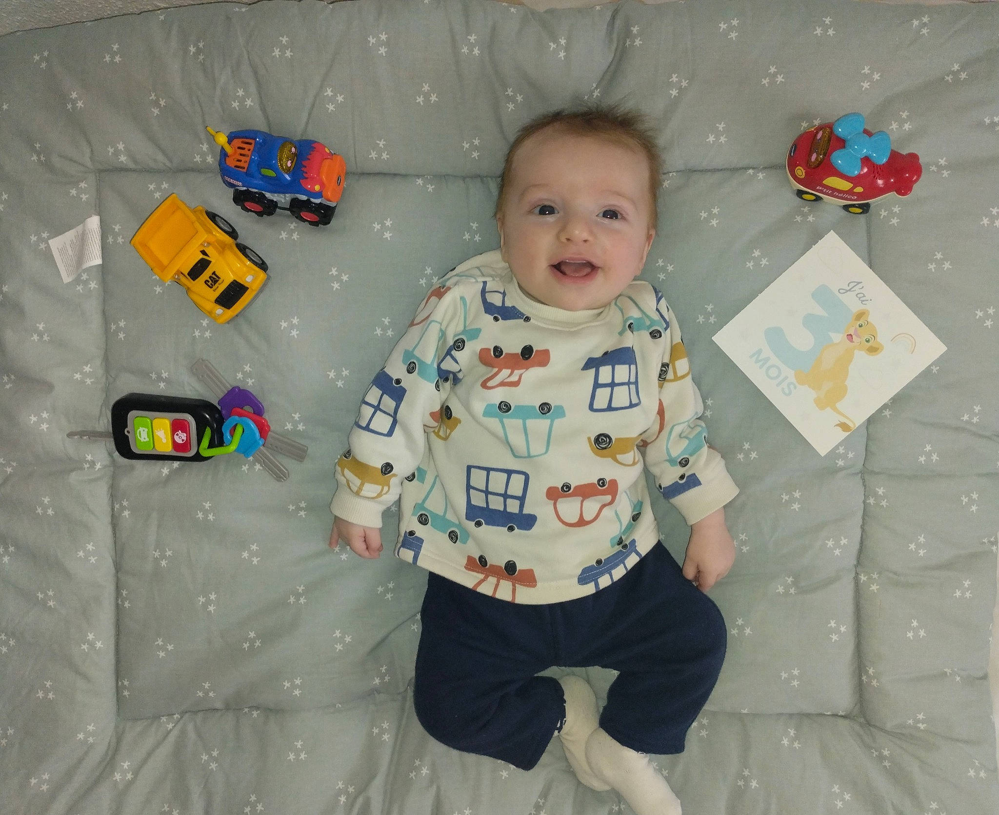 Aylan participe au concours pour gagner de l'argent avec cette photo : baby, baby_toddler_clothing, baby_toys, child, comfort, design, fun, happy, linens, pattern, person, play, product, room, sleeve, smile, t_shirt, textile, toddler