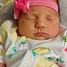 newborn, baby, sleeping, headband, pink, flower, onesie, fruit_pattern, infant, child, cute, peaceful, portrait, soft_lighting, indoors, closeup, face, clothing, resting, adorable