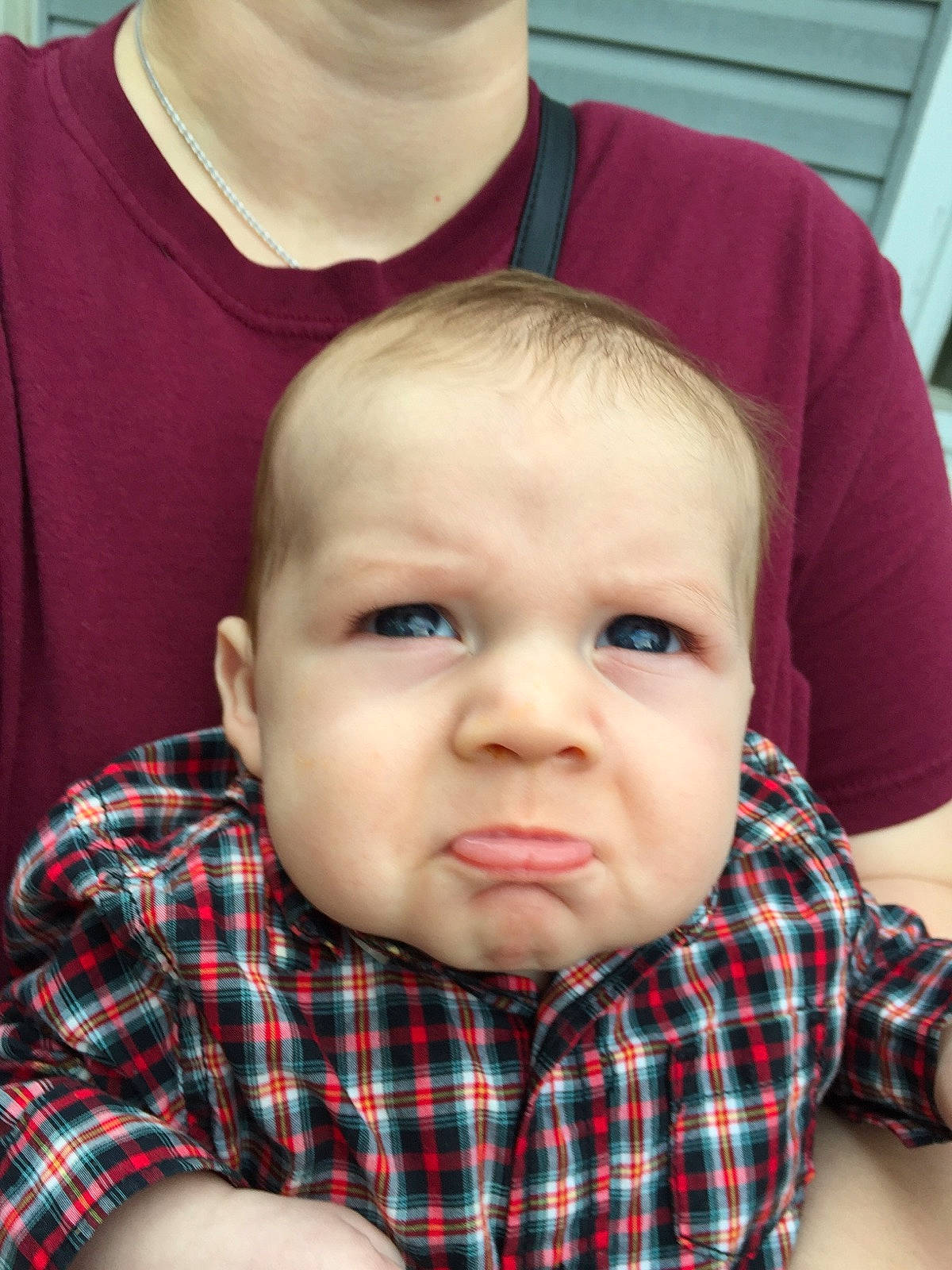 Bishop is registered to the contest to win money with this photo: baby, cheek, child, chin, design, face, forehead, head, lip, mouth, nose, pattern, people, person, plaid, sitting, skin, smile, sorrow, tartan