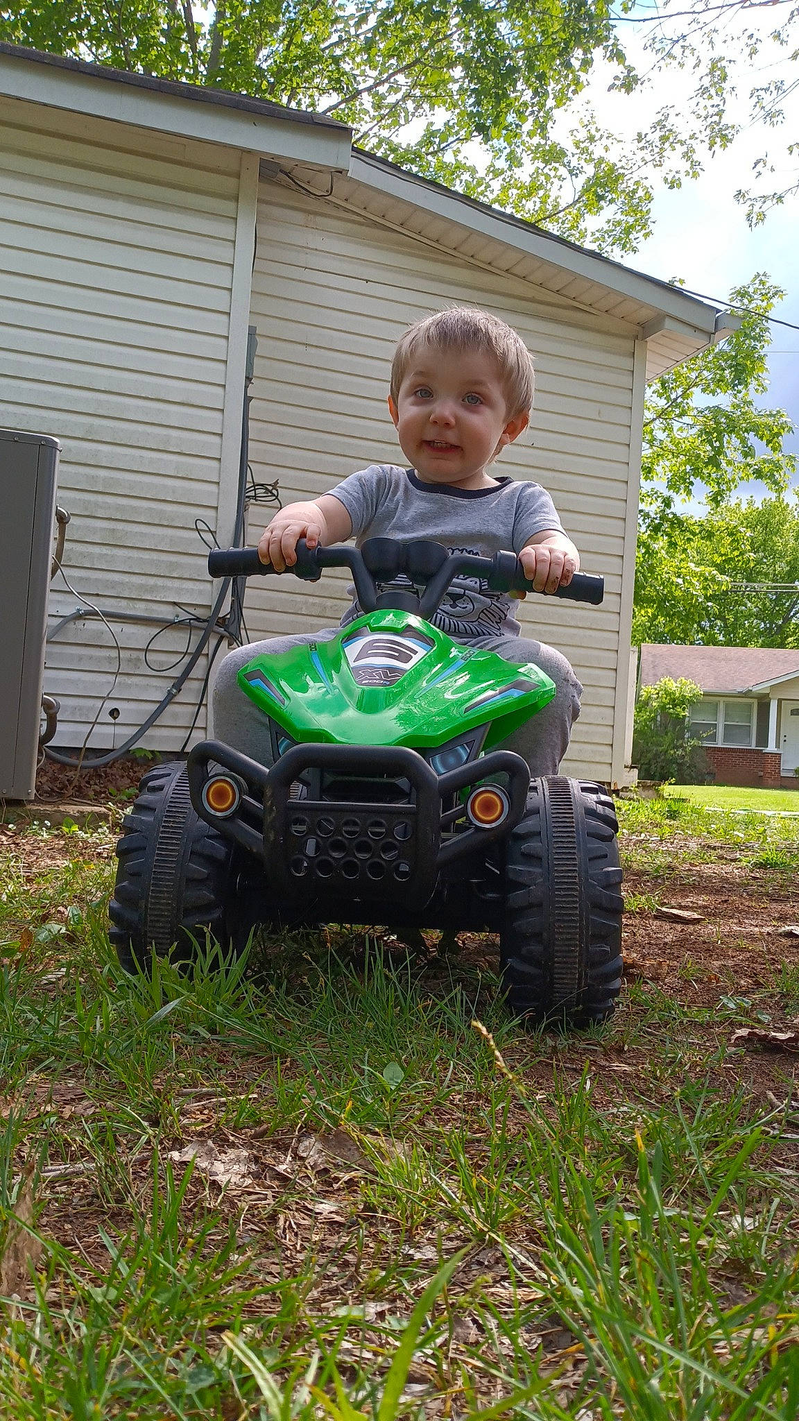Aubrey V joined the competition — help win amazing prizes! all_terrain_vehicle, automotive_exterior, automotive_tire, automotive_wheel_system, baby_toddler_clothing, grass, house, joy, lawn, motor_vehicle, person, plant, riding_toy, sky, t_shirt, tire, toddler, tread, tree, vehicle