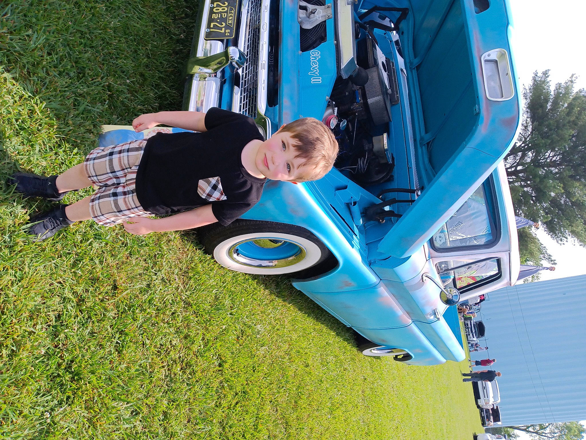 Armani joined the competition — help win amazing prizes! automotive_design, automotive_exterior, automotive_tire, automotive_wheel_system, baby, bumper, car, electric_blue, fun, grass, hood, joy, leisure, motor_vehicle, person, recreation, tire, toddler, tree, vehicle