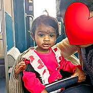 Sonakshi a rejoint le concours — aidez-le/la à gagner de superbes lots ! child, toddler, pink_clothing, pony_tail, stroller, safety_bar, adult, heart_emoji, bus_interior, window, hand, seat, curious, indoor, person, transportation, public_transport, face, holding, casual