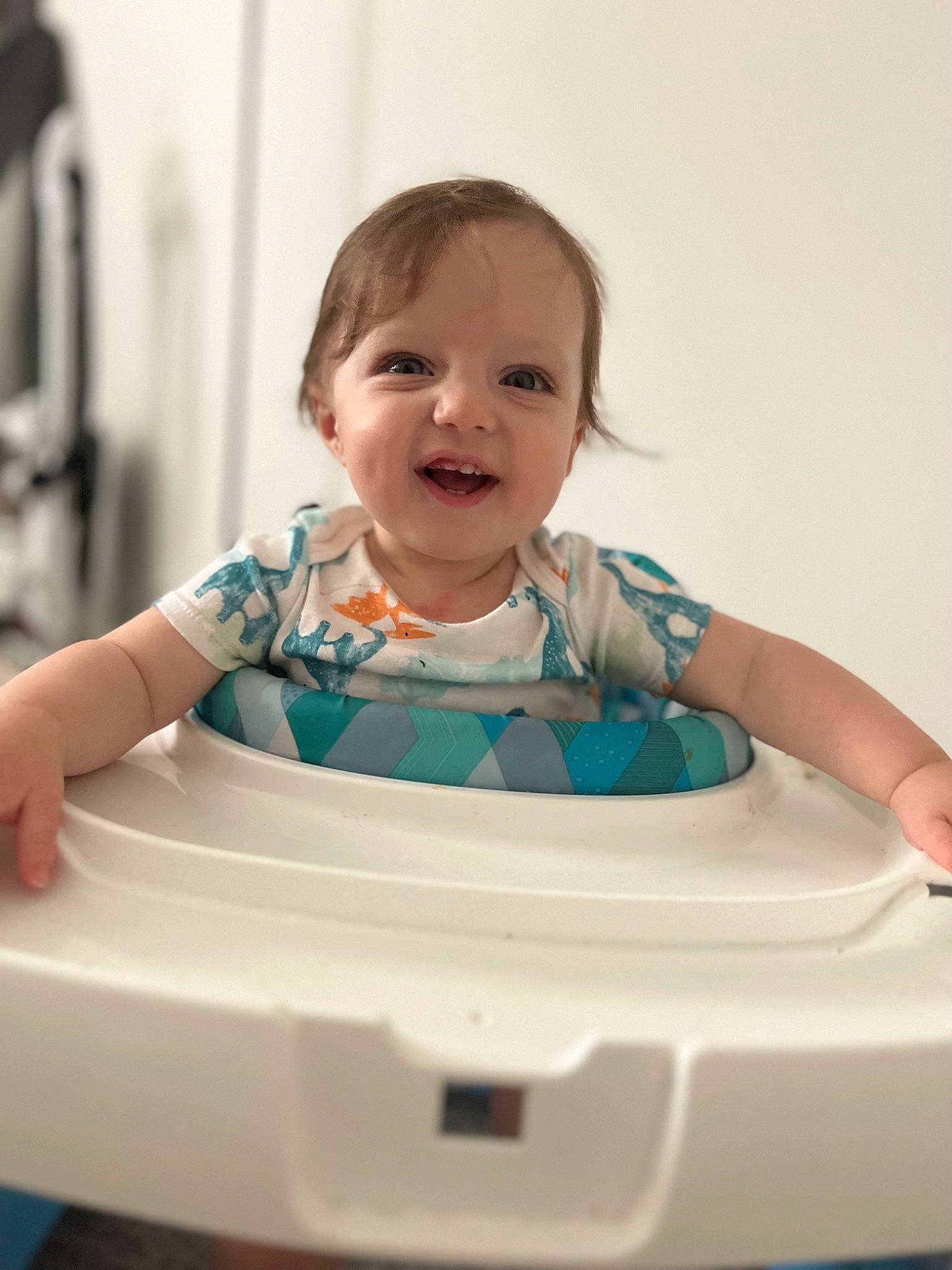 Nicholas is registered to the contest to win money with this photo: baby, baby_toddler_clothing, cheek, child, circle, facial_expression, finger, fun, happy, pattern, people, person, play, room, sitting, skin, sleeve, smile, standing, t_shirt