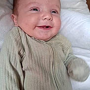 Leo joined the competition — help win amazing prizes! baby, smiling, infant, face, clothing, ribbed_fabric, cushion, white, happy, lying_down, closeup, portrait, child, soft, cute, indoors, skin, head, eyes, mouth