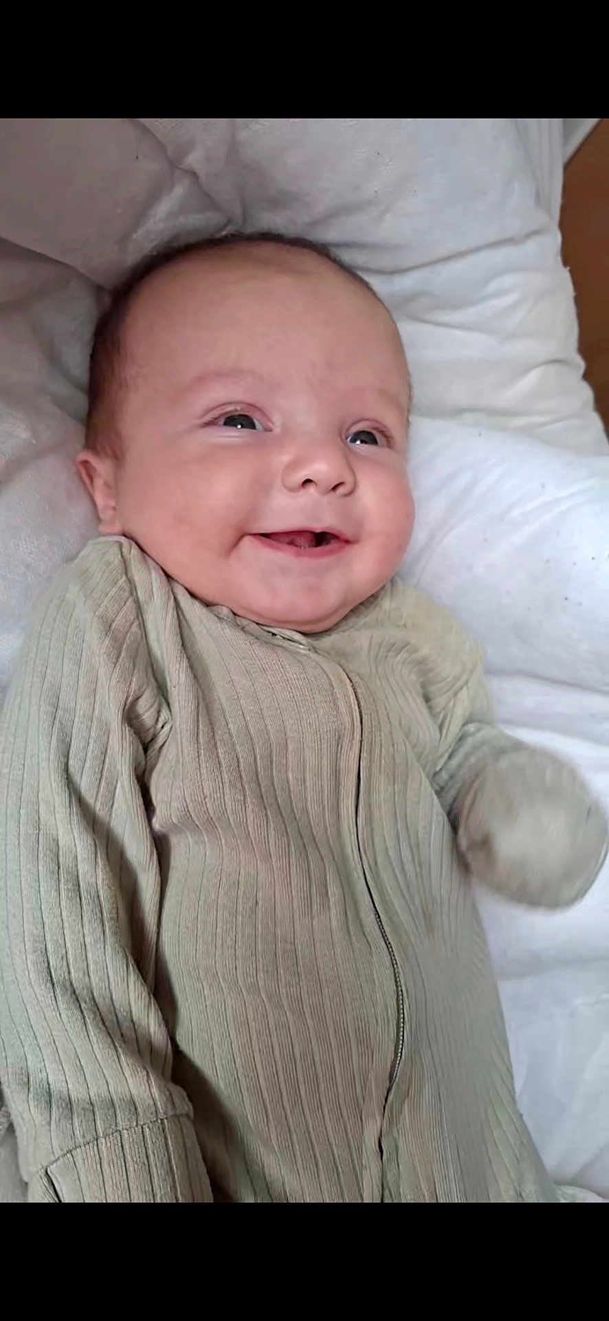 Leo joined the competition — help win amazing prizes! baby, smiling, infant, face, clothing, ribbed_fabric, cushion, white, happy, lying_down, closeup, portrait, child, soft, cute, indoors, skin, head, eyes, mouth